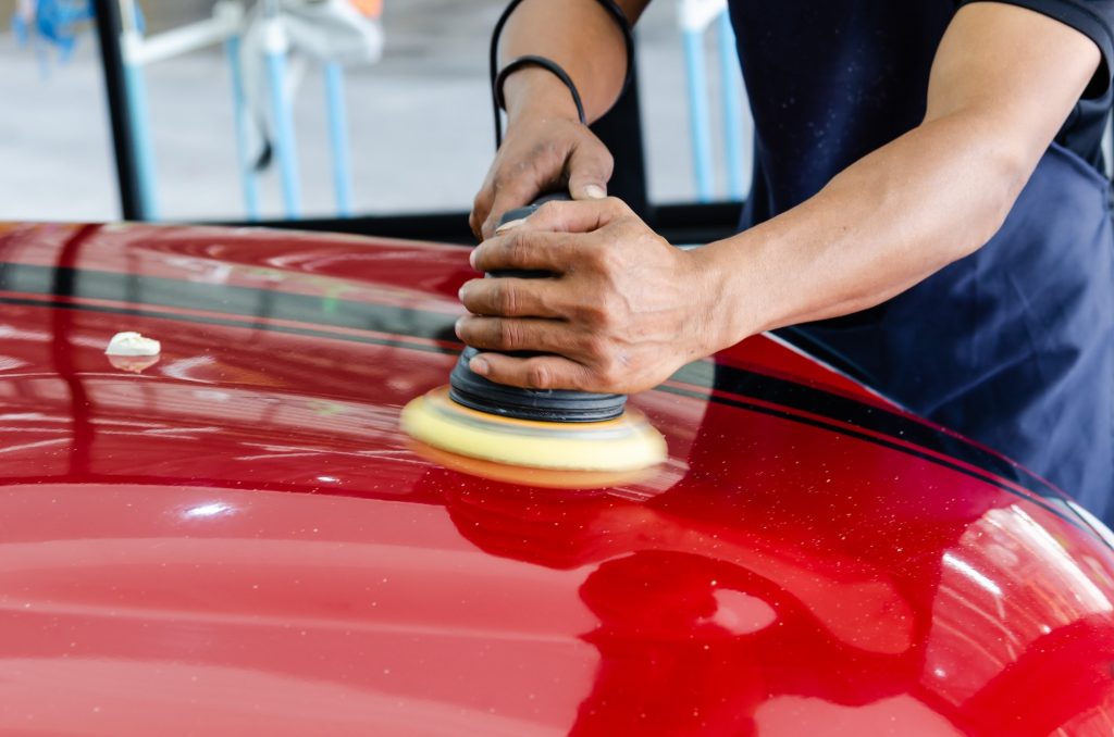 Car detailing.Man hand holding and polish the car.Polishing car wax.